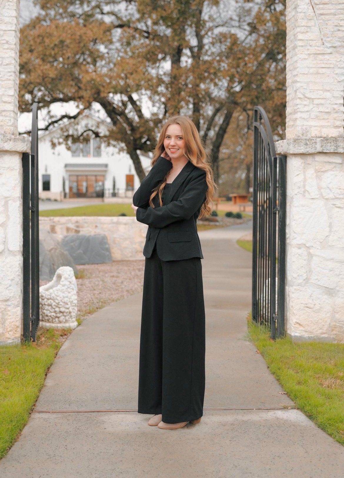 Bailey Elaine standing at a garden gate