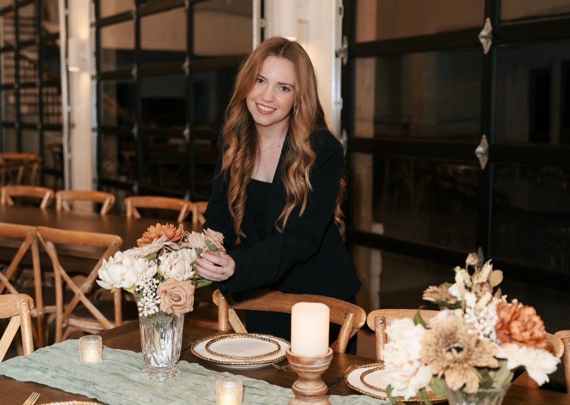 Bailey Elaine styling a reception table with fresh florals