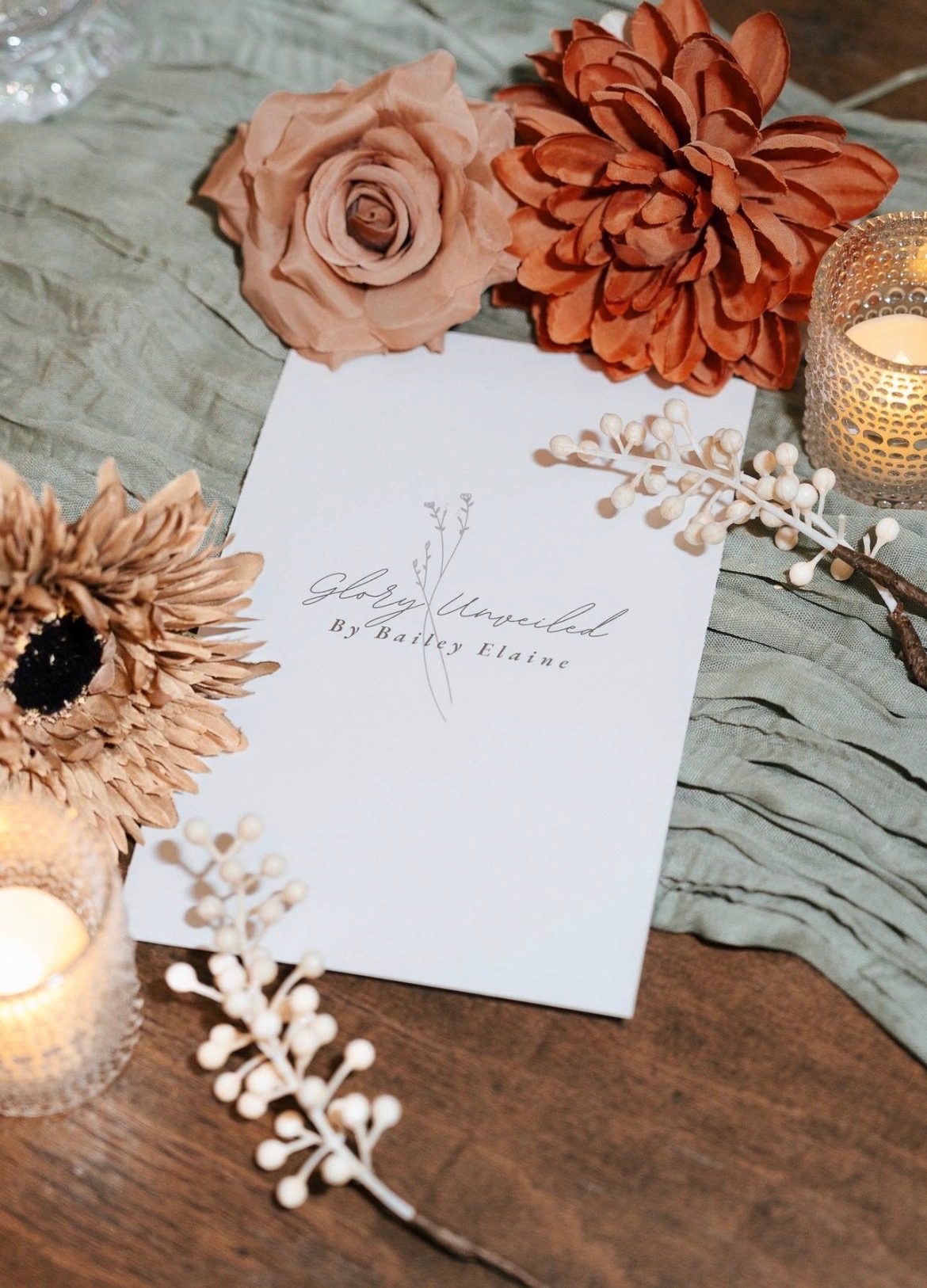 Glory Unveiled menu card styled with dried florals and candlelight